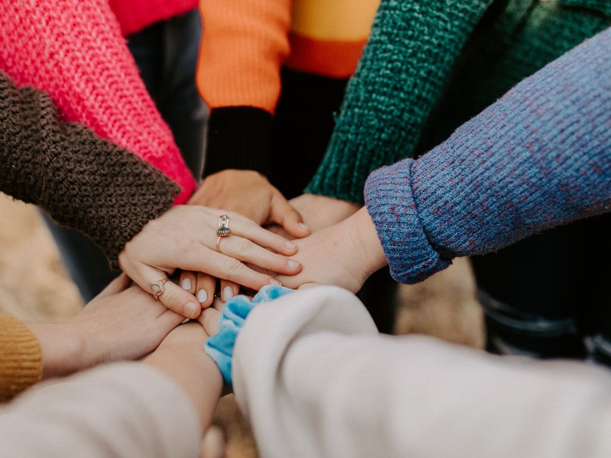 Volunteers joining hands together at a community event