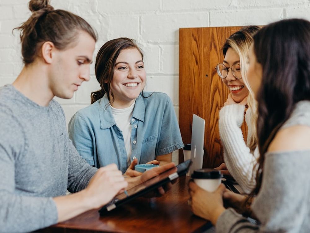 A small team working together around a table on a website project